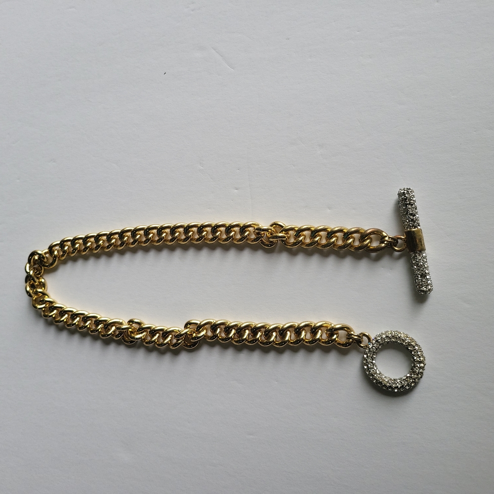 Chain linked Gold tone necklace w/rignestone accent lock.